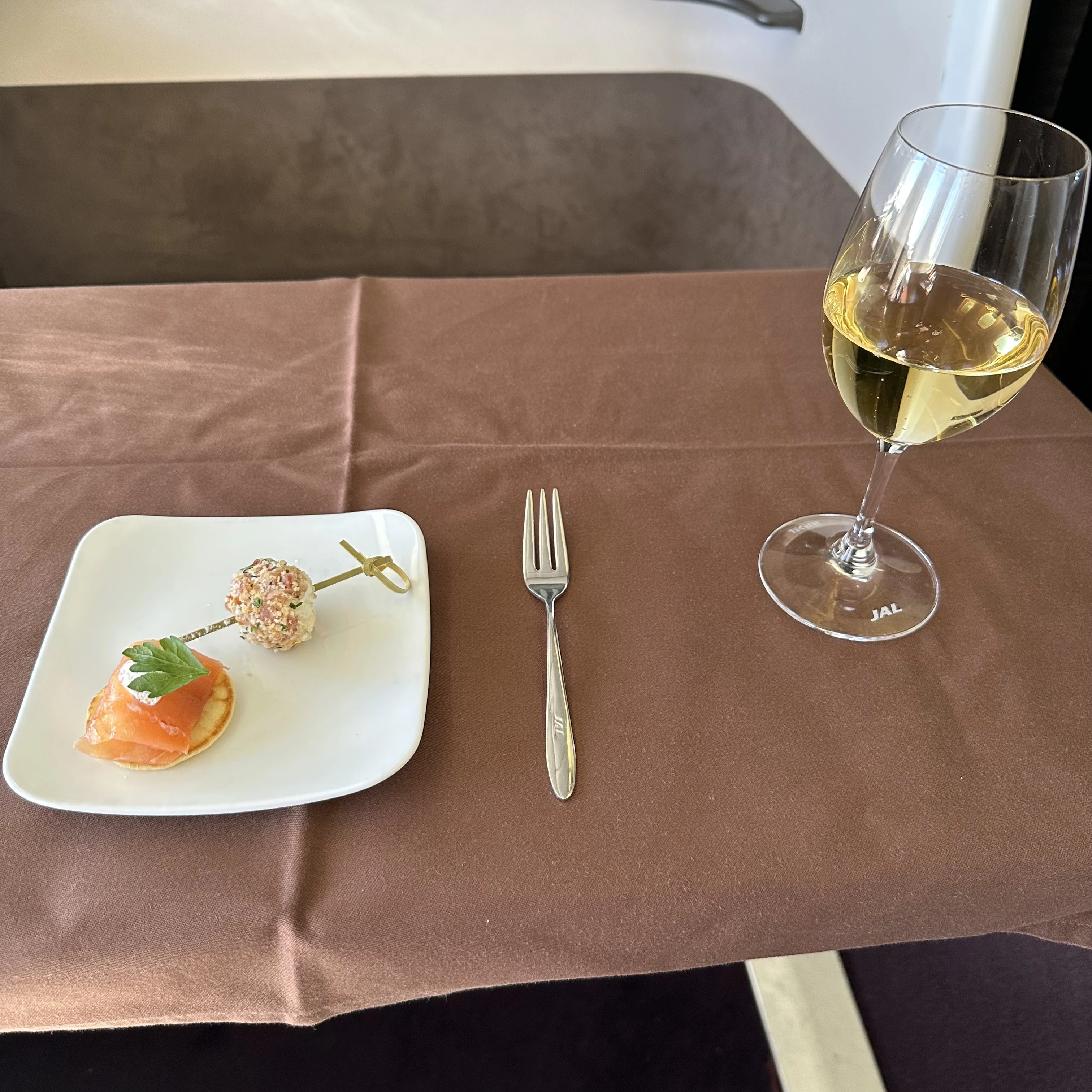 Japan Airlines Boeing 777-300ER First Class pre departure drink and appetizer.