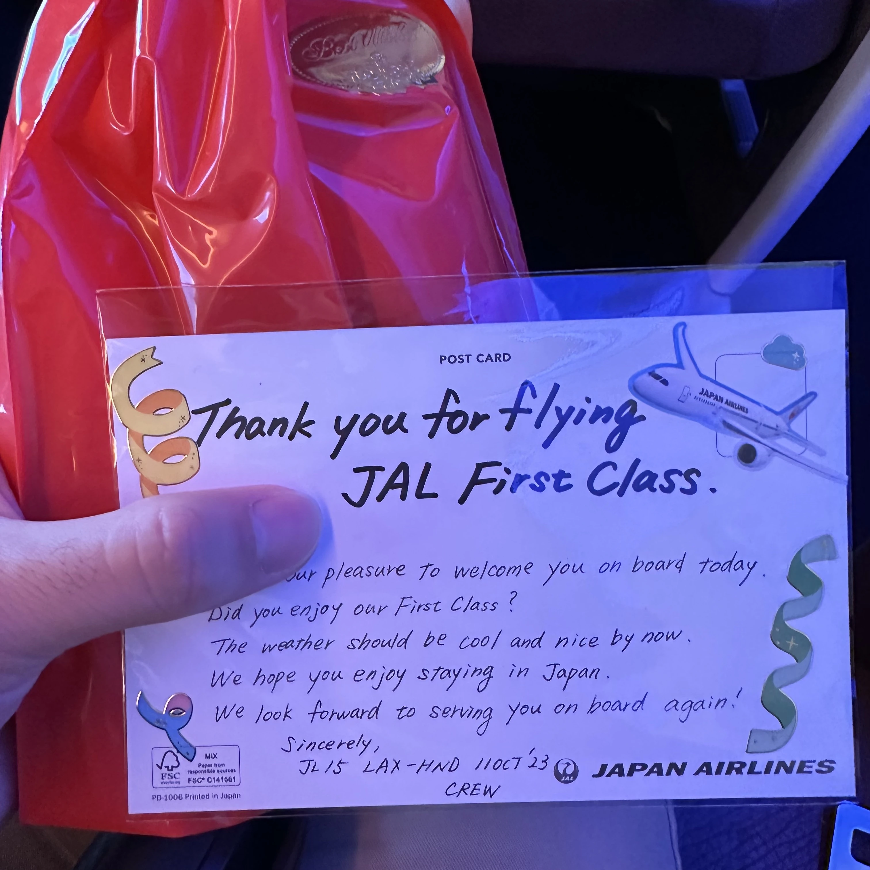 Japan Airlines Boeing 777-300ER First Class hands out a gift bag and handwritten note.