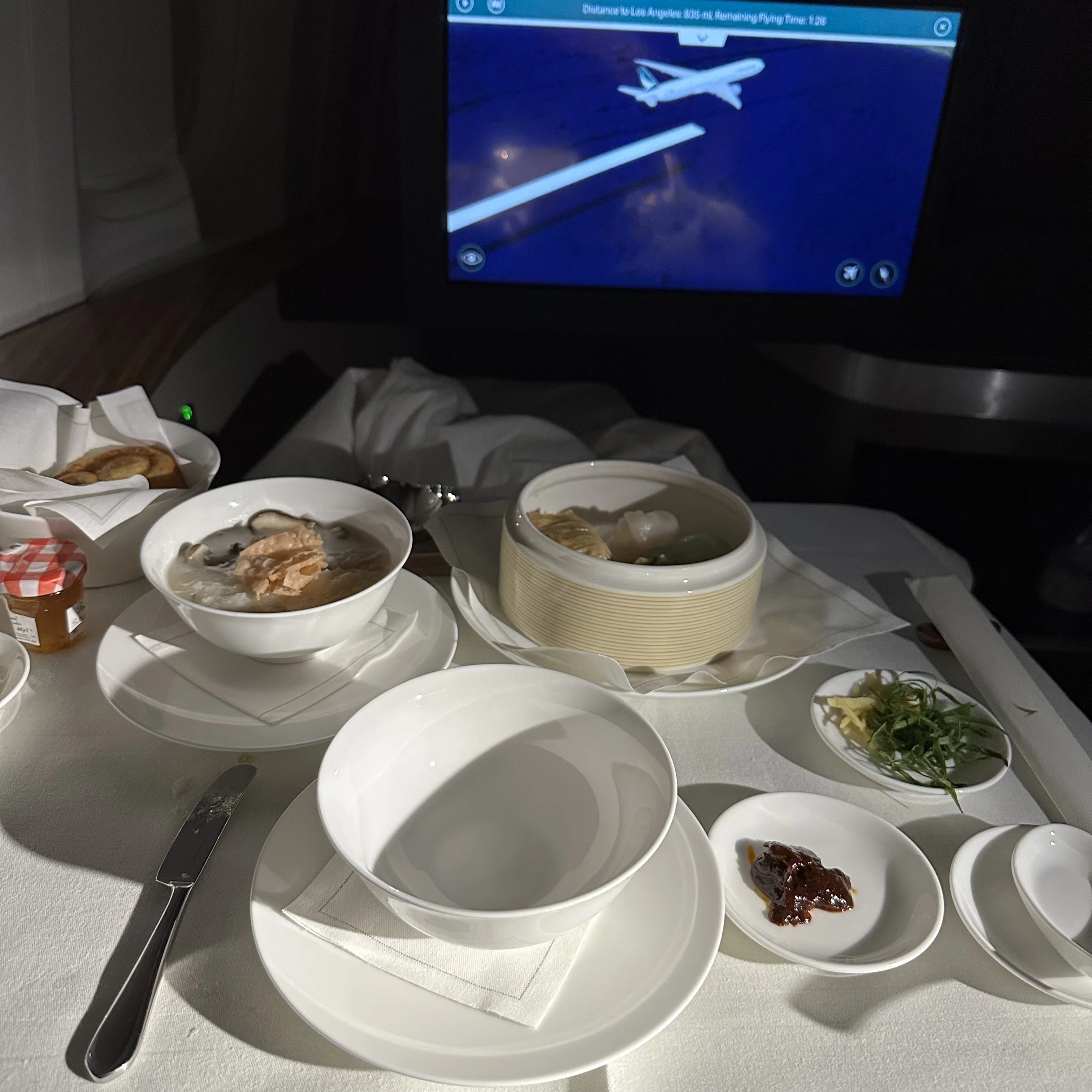 Cathay Pacific First Class Asian-style breakfast featuring congee and dim sum.