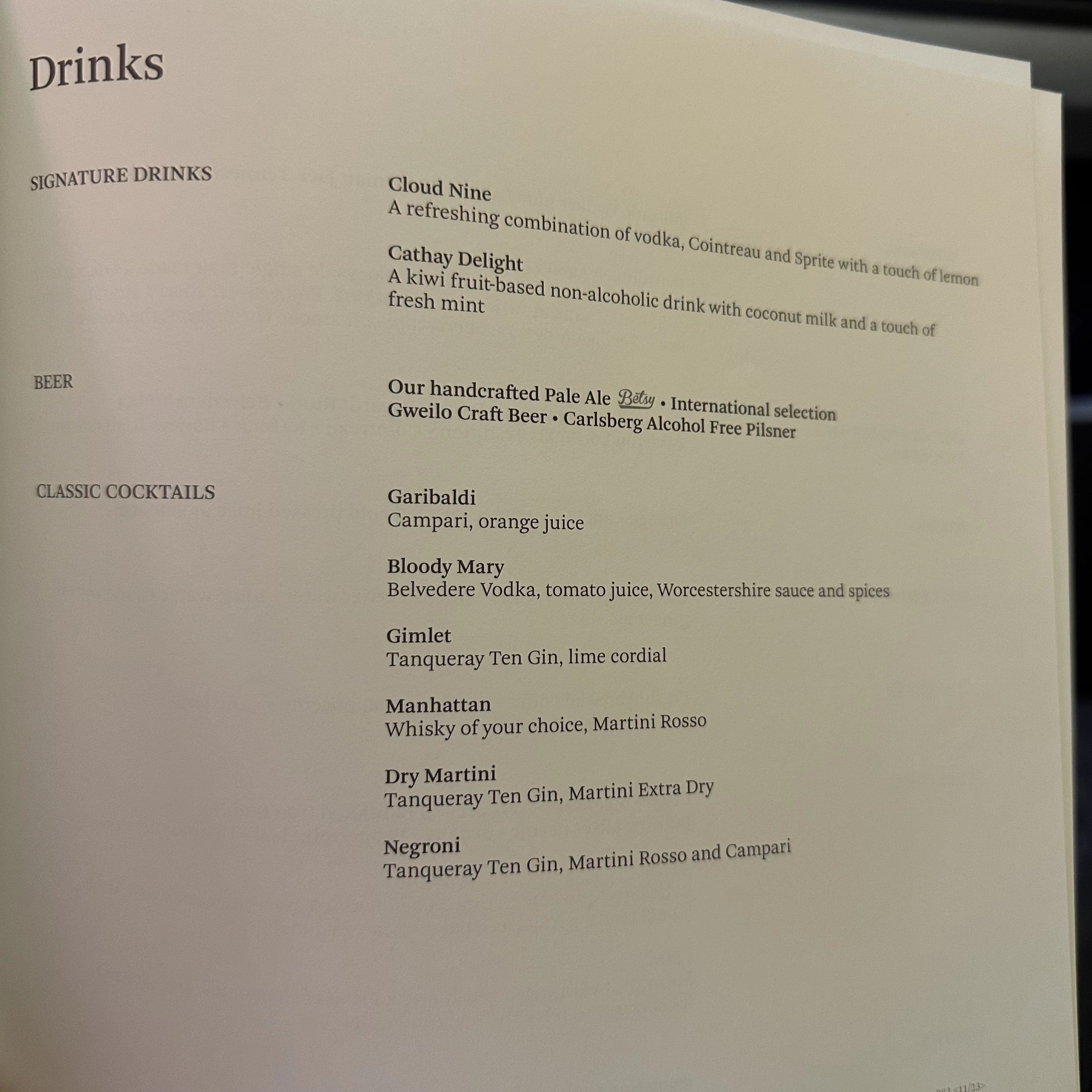 Cathay Pacific First Class menu with premium alcoholic beverages and champagne.