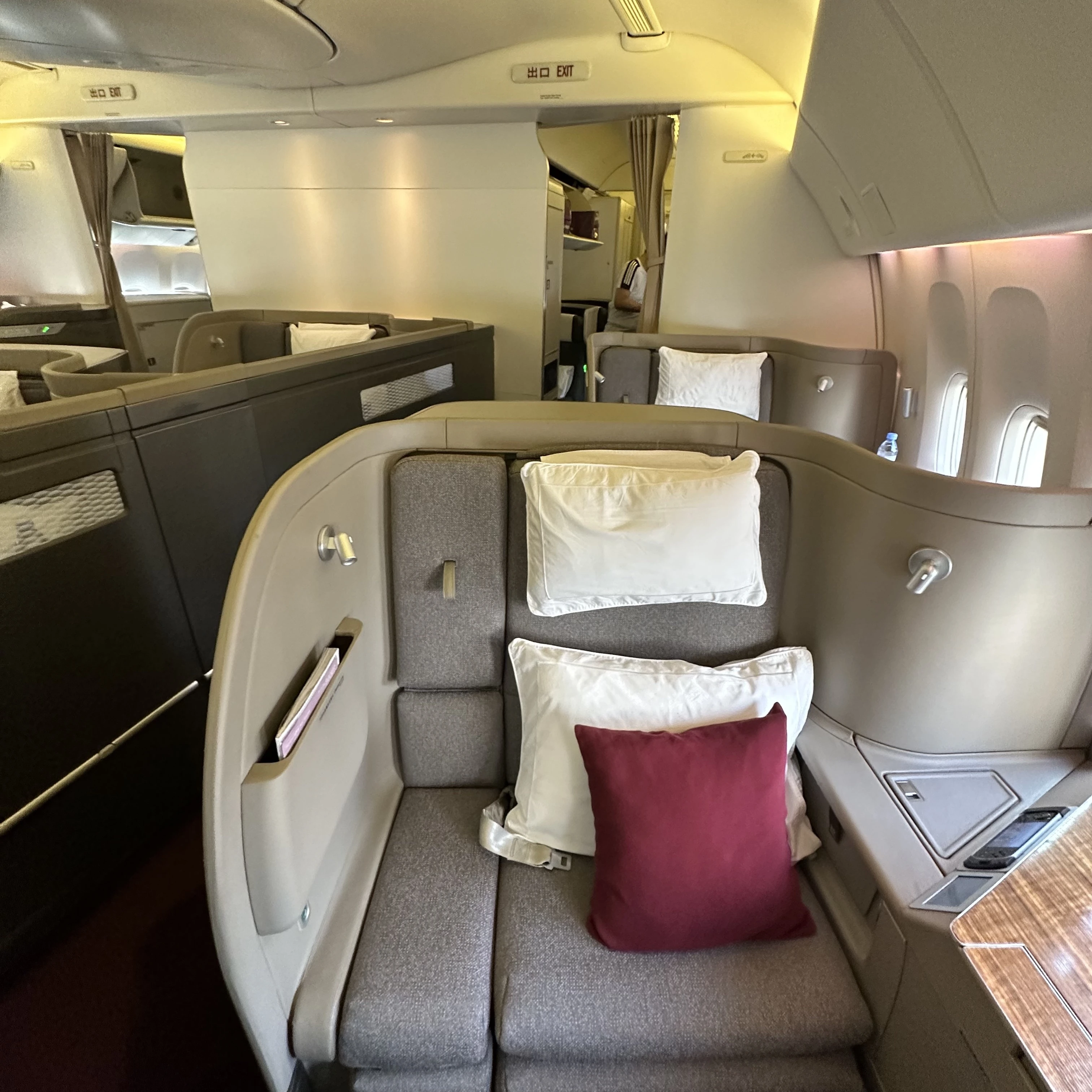 Cathay Pacific 777-300ER First Class cabin with spacious and private seating.