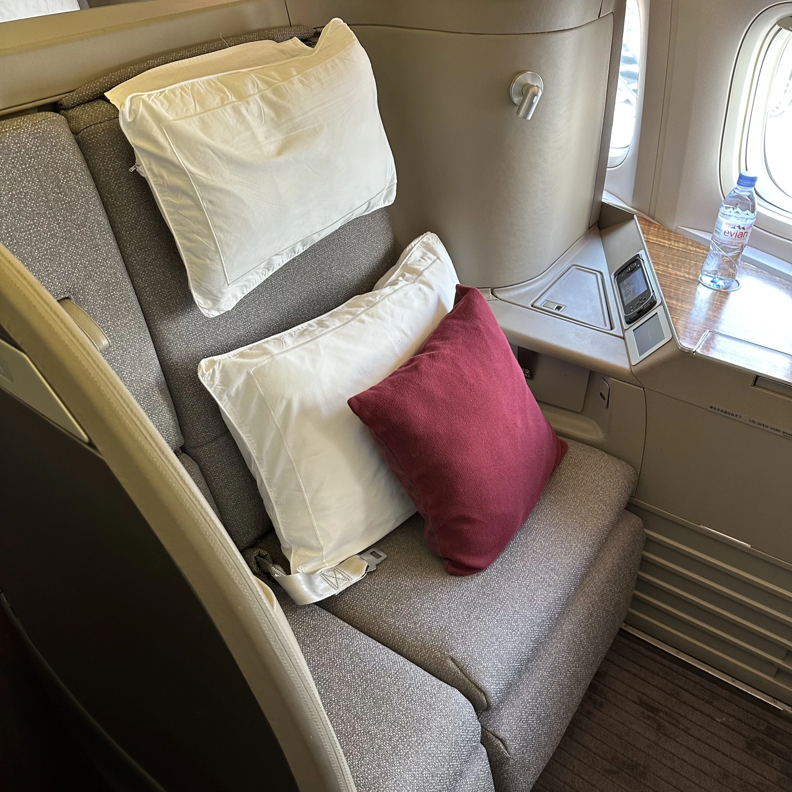 Cathay Pacific 777-300ER First Class seat showcasing luxurious design and wide space.