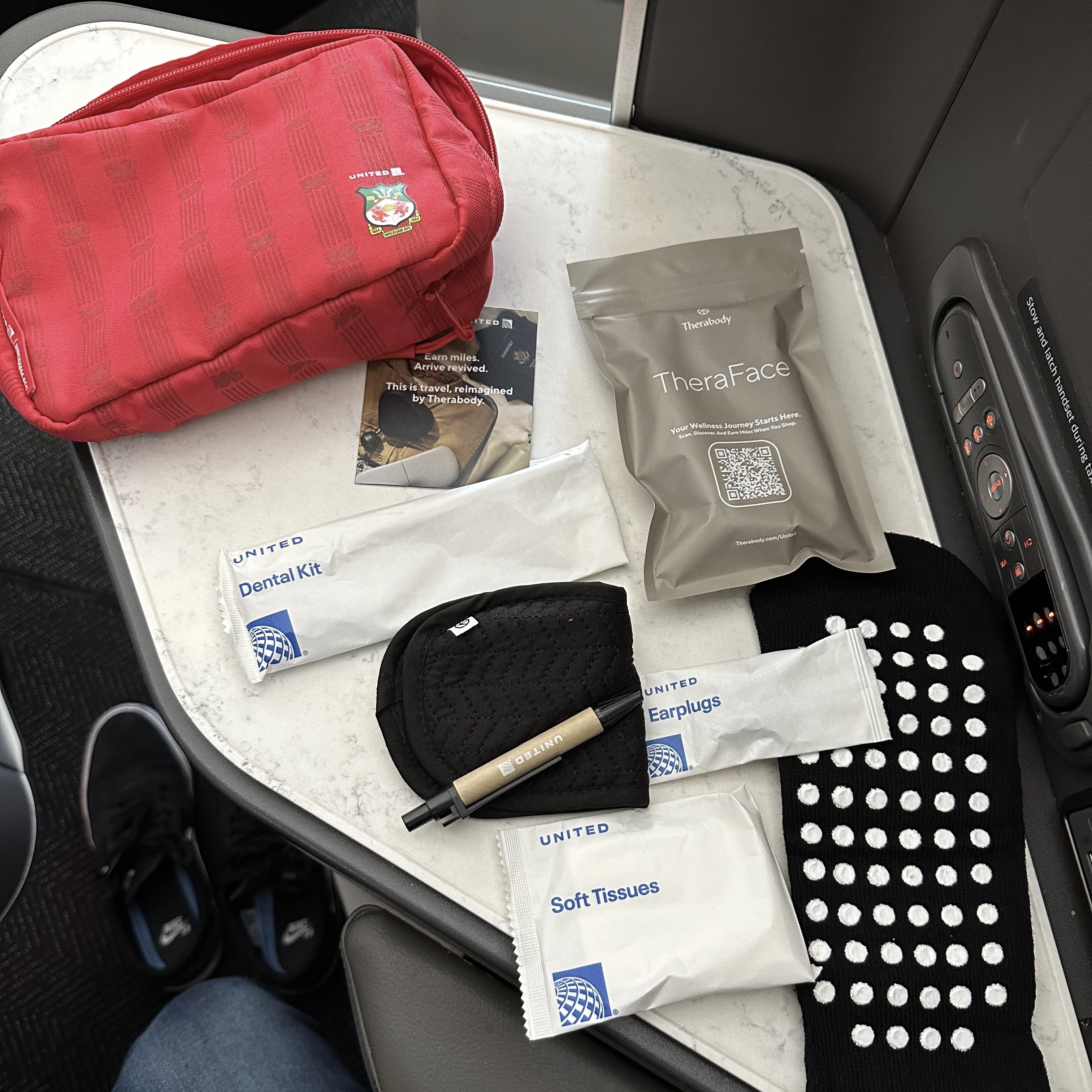 Contents of the amenity kit provided in United Polaris Business Class, including an eye mask and personal care items.