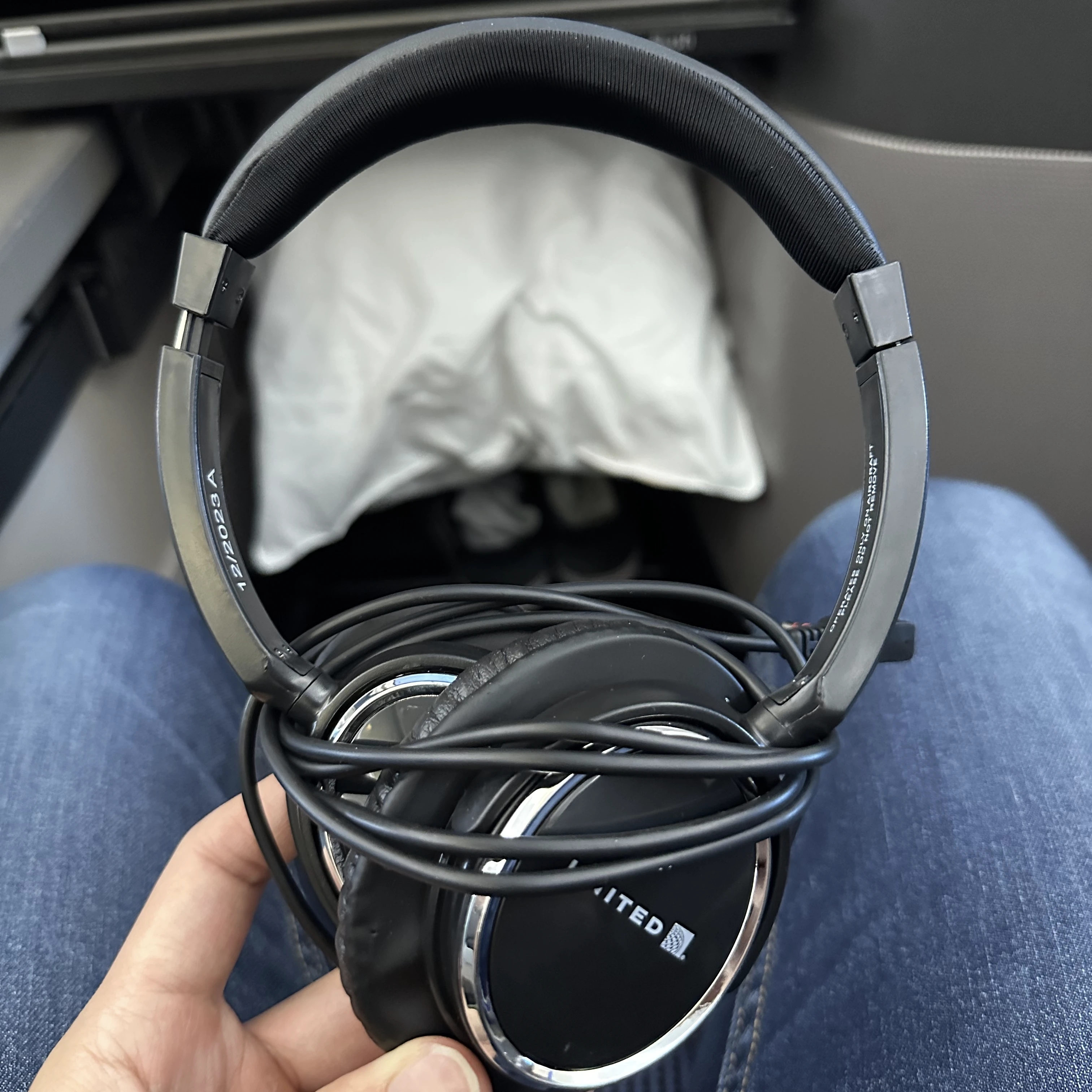 Complimentary noise-cancelling headphones provided in United Polaris Business Class for an immersive entertainment experience