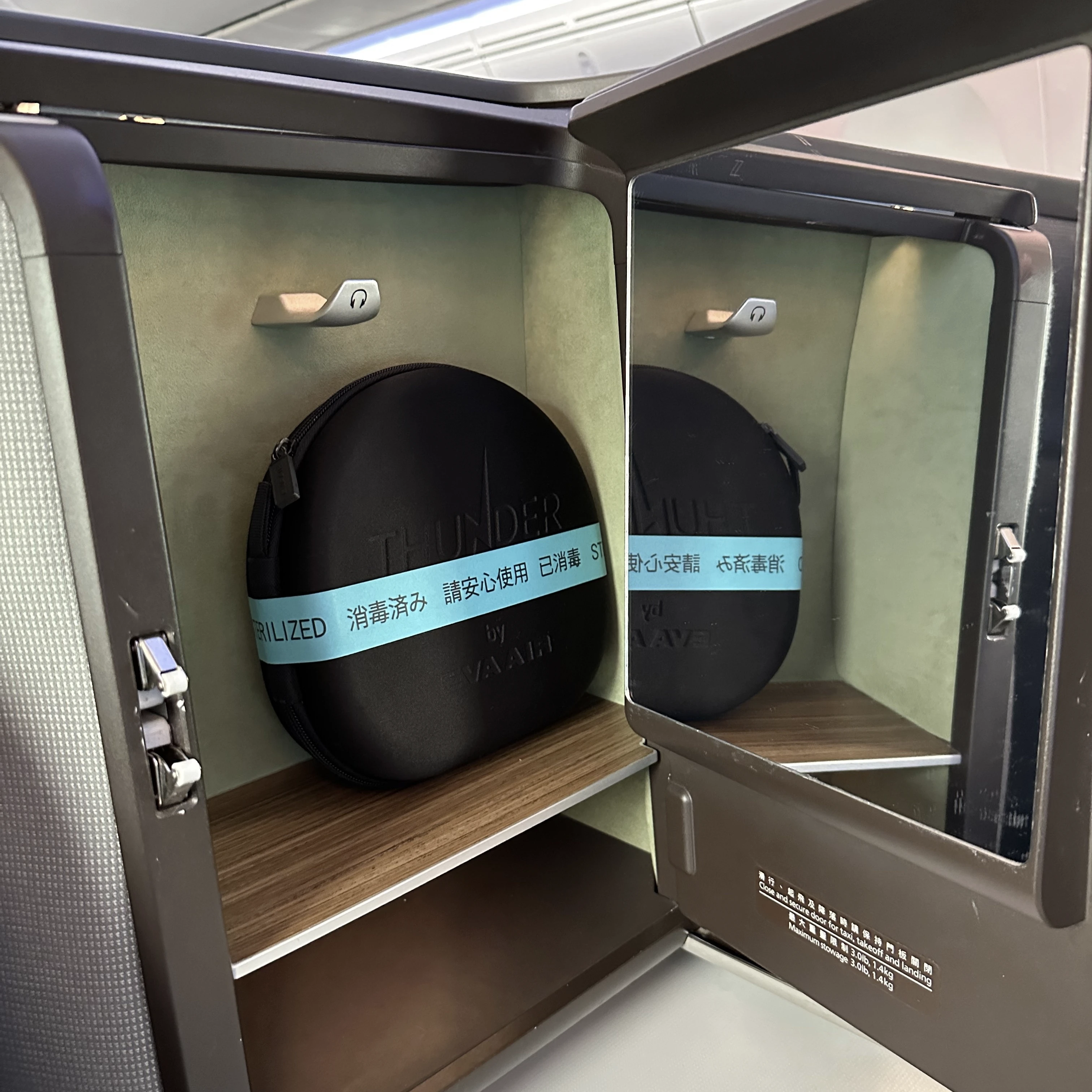 Eva Air Boeing 787-10 business class has a storage cubby and noise-cancelling headphones.