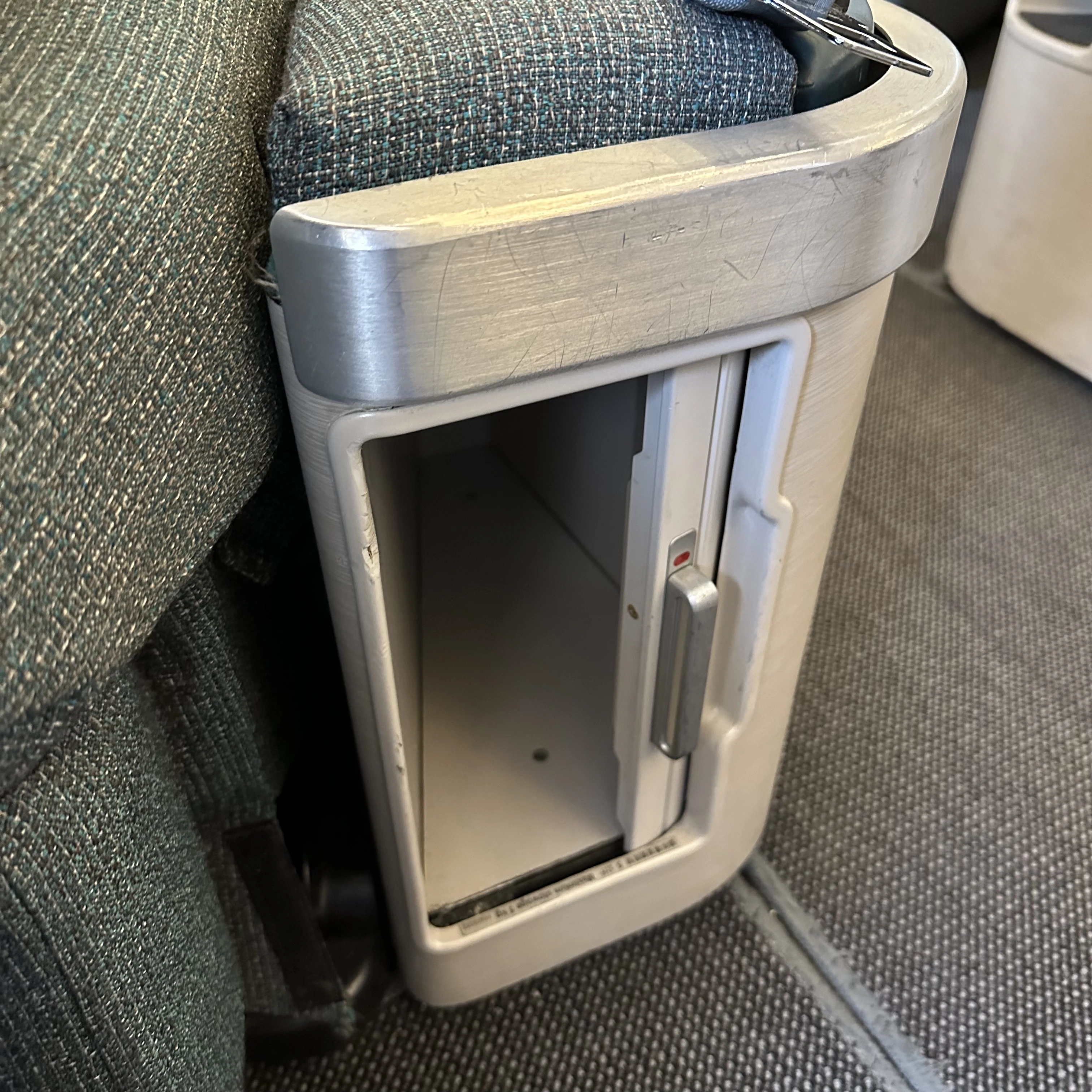 Cathay Pacific Airbus A330-300 business class seat storage cubby.