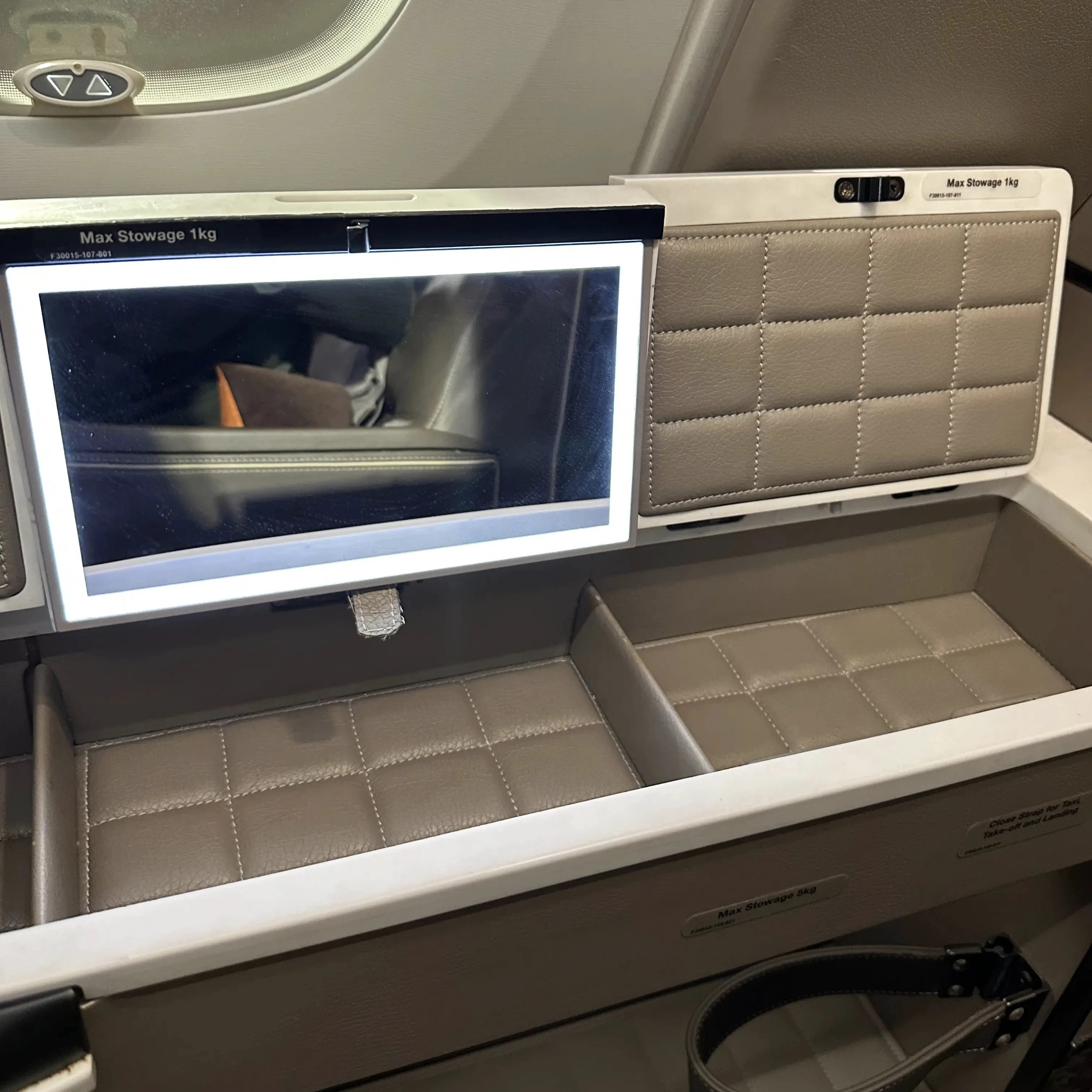 Singapore Airlines A380-800 First Class Suites seats have storage cubbies.